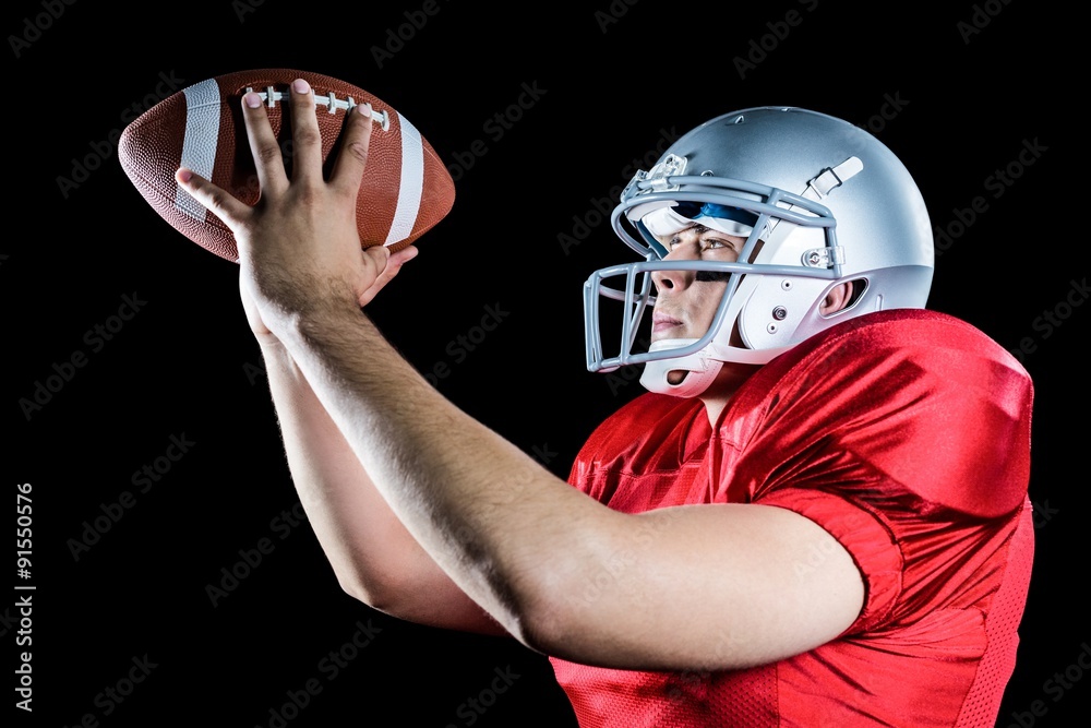 Side view of American football player throwing ball Side view of American football player throwing ball