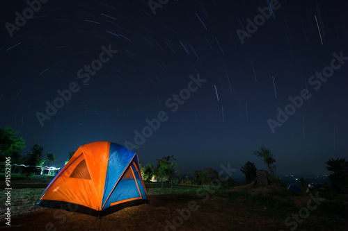 Spiral star trail with colorful tent