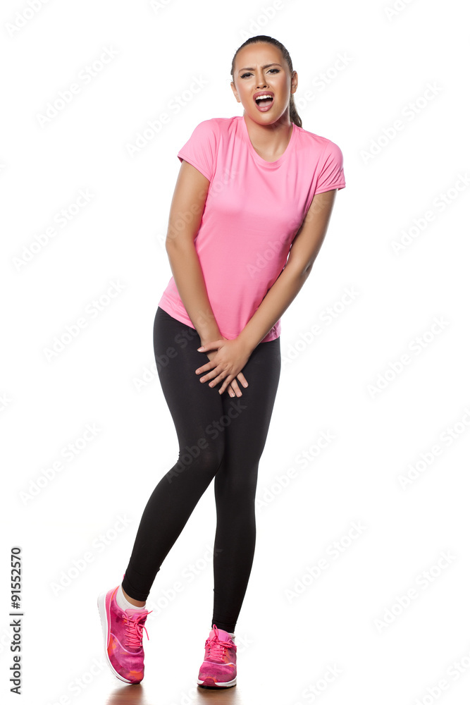 beautiful young athlete has the need for toilet beautiful young athlete has the need for toilet