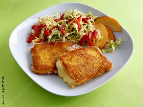 scrambled,coated in bread-crumbs and eggs cheese with vegetable salad 