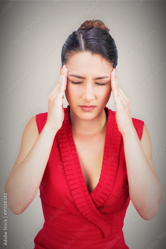 Composite image of sexy tied haired brunette having headache Composite image of sexy tied haired brunette having headache