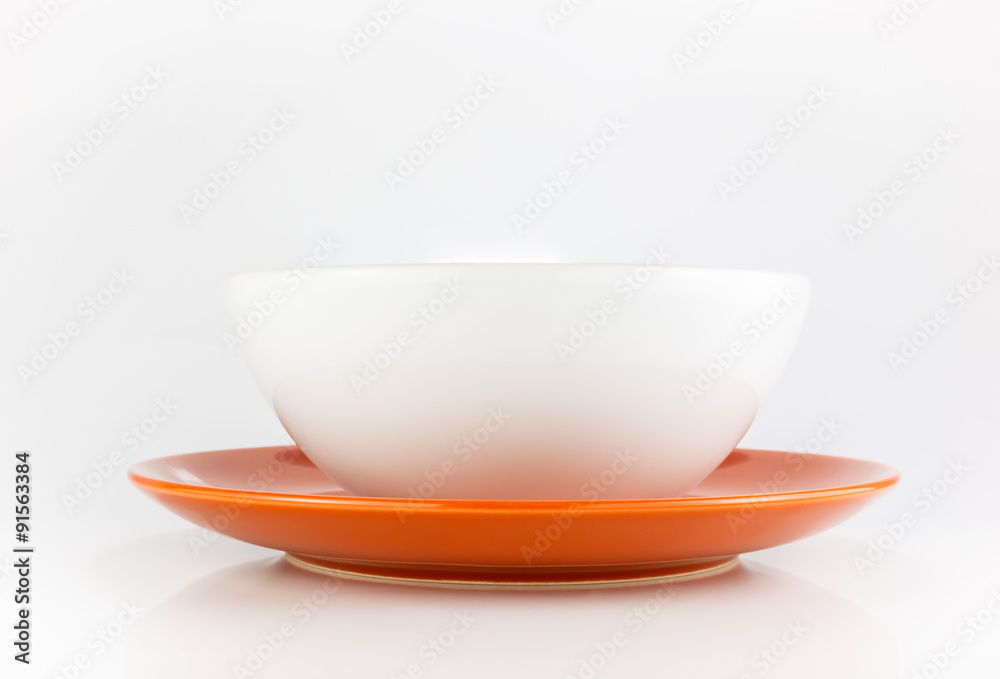 Bowl and orange empty plate.