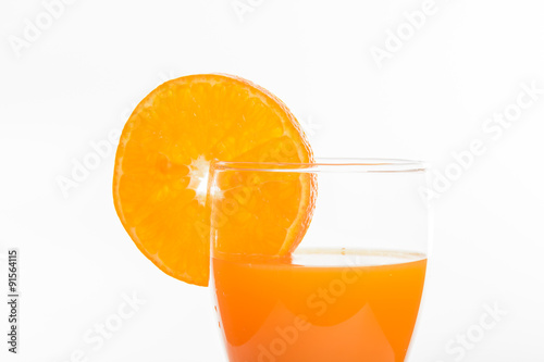 Orange juice in glass and slices orange