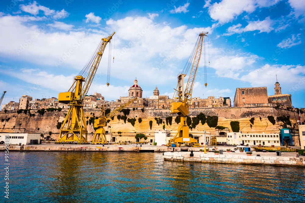 cranes and docks on the shore of Malta