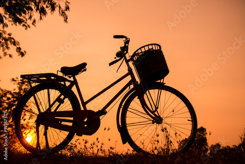 beautiful landscape image with Bicycle silhouette at sunset © Looker_Studio