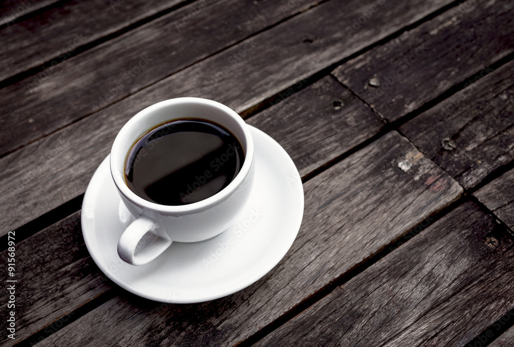 Hot black coffee with space on dark wooden floor Hot black coffee with space on dark wooden floor