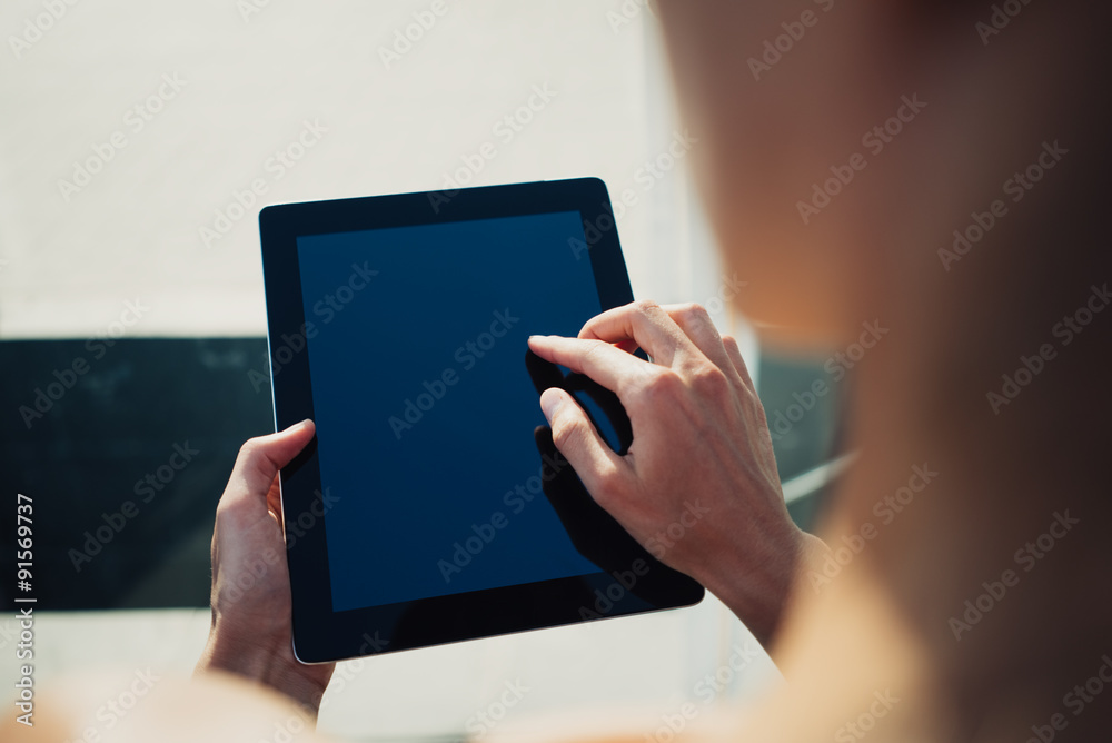 Girl using her tablet in the city