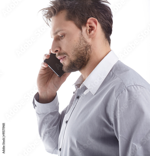 Cool businessman talking on mobile phone