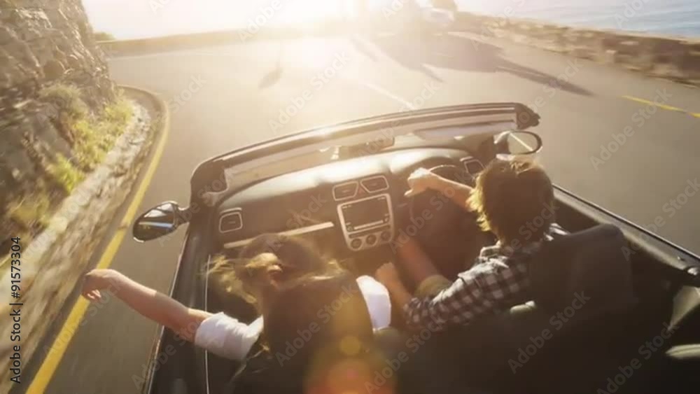 Couple driving convertible car cabriolet cape town south africa steadicam shot