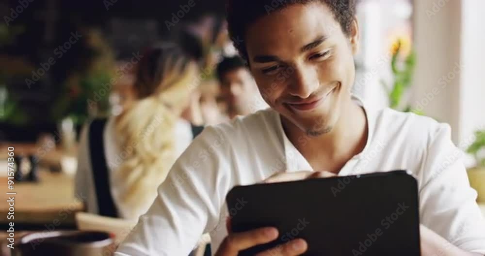 Mixed race man using digital display touchscreen tablet ipad device in cafe
