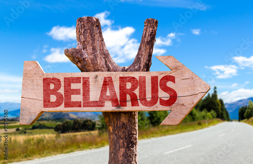 Belarus wooden sign with road background photo