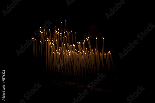 Candles in Church. In Europe, people light candles inside the churches . The candles are lit with a prayer, usually to remember someone or to help with an issue.