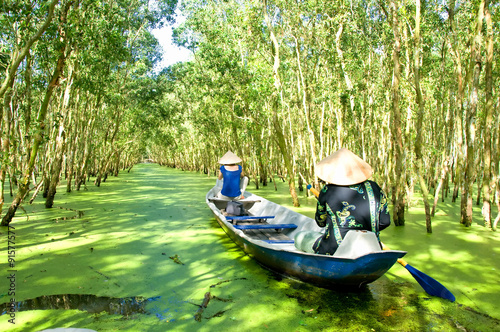 Quadro su tela Tourism rowing boat in Tra Su flooded indigo plant forest in An Giang, Mekong delta, Vietnam