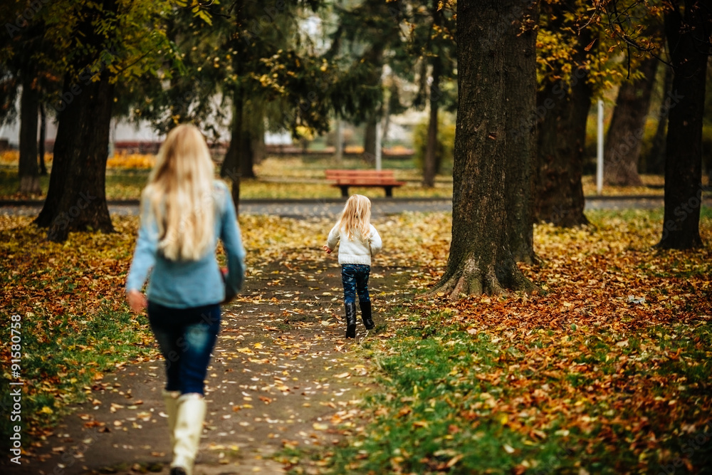 Mother with daughter in autumn park Mother with daughter in autumn park
