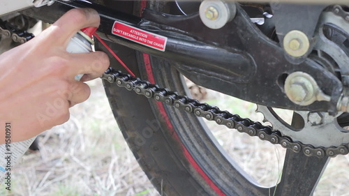 Chain lubrication motorcycle from a container. photo