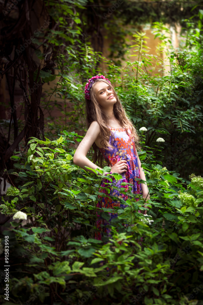 Portrait of beautiful young woman posing at garden Portrait of beautiful young woman posing at garden