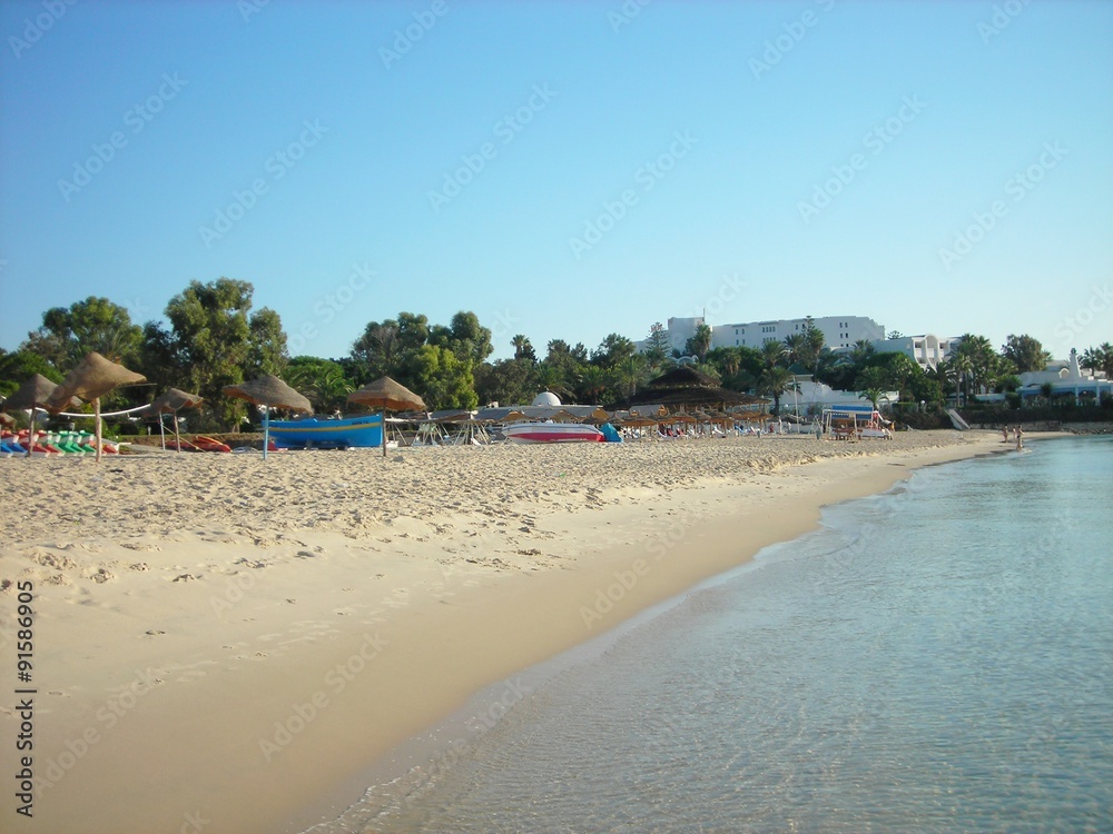 Sandy beach in the Tunisian seaside resort Hammamet on a sunny afternoon in early fall.