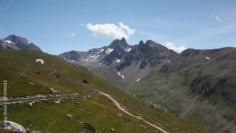 Paraglider above the deep valley. Panorama of the Upper Engadine from Muottas Muragl. Paraglider above the deep valley. Panorama of the Upper Engadine from Muottas Muragl.