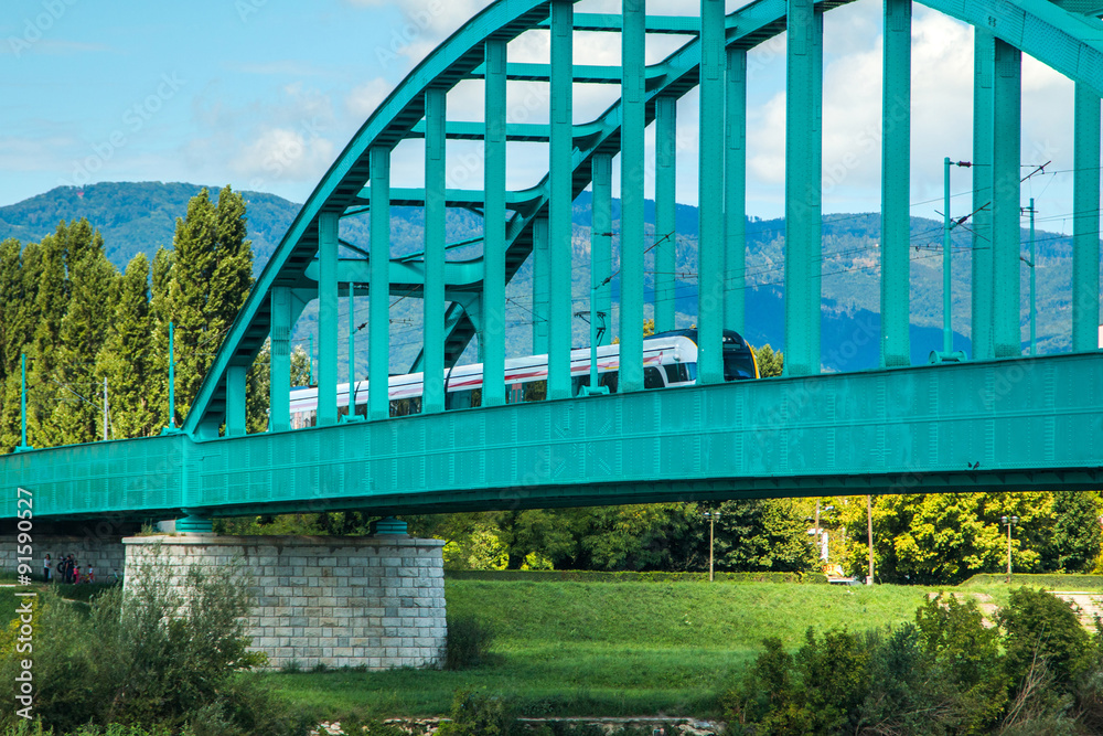 New modern fast train crossing green Railway bridge over Sava river in Zagreb, Croatia
New modern fast train crossing green Railway bridge over Sava river in Zagreb, Croatia