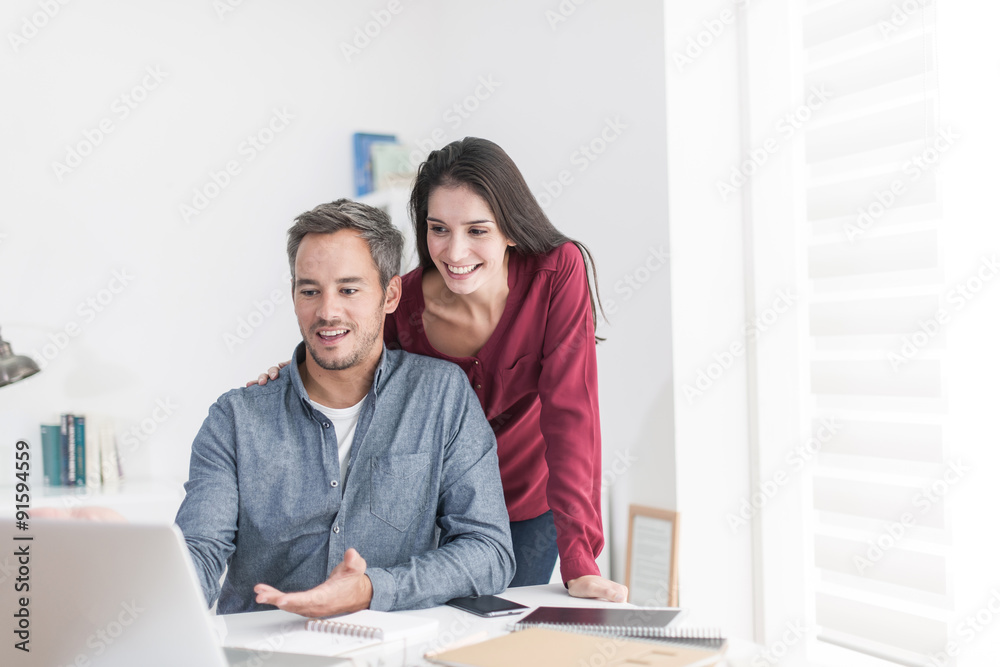 Portrait of a smiling couple planning their next trip, the grey Portrait of a smiling couple planning their next trip, the grey