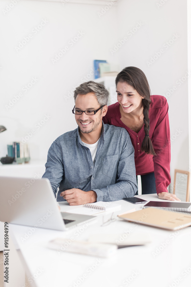 Portrait of a smiling couple planning their next trip, the grey Portrait of a smiling couple planning their next trip, the grey