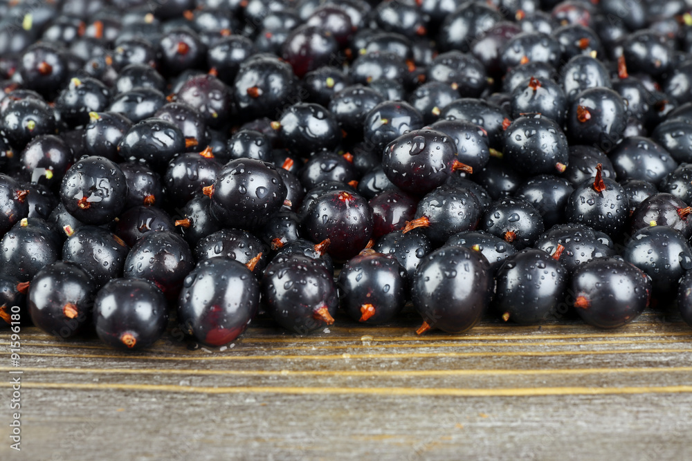 Heap of wild black currant on wooden table close up