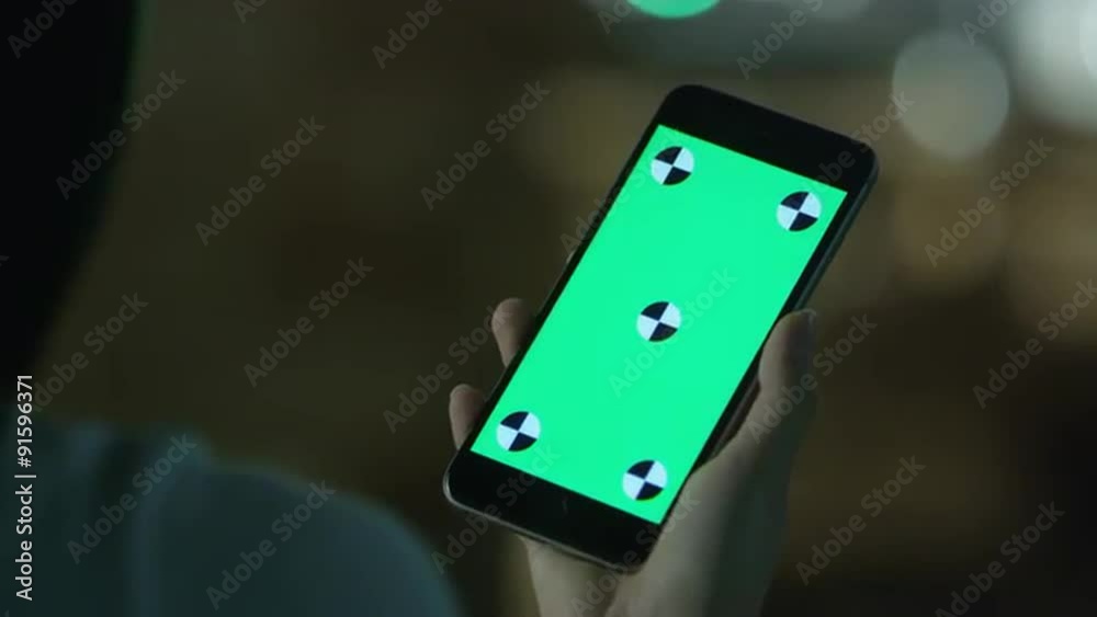 Young Girl is Holding Phablet with Green Screen at Evening Time. Casual Lifestyle.