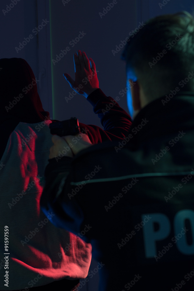 Cop pointing handgun at offender