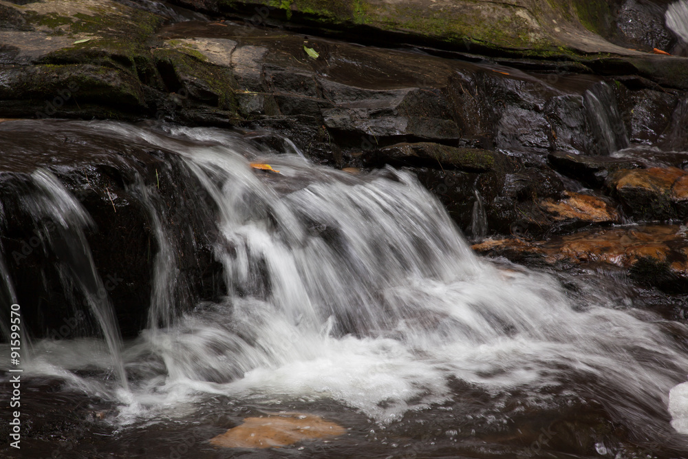 Fototapeta premium Mountain waterfall tumbling over rocks