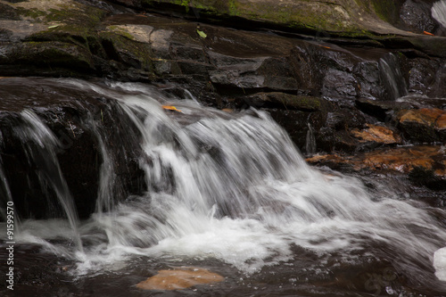 Fototapeta Naklejka Na Ścianę i Meble -  Mountain waterfall tumbling over rocks