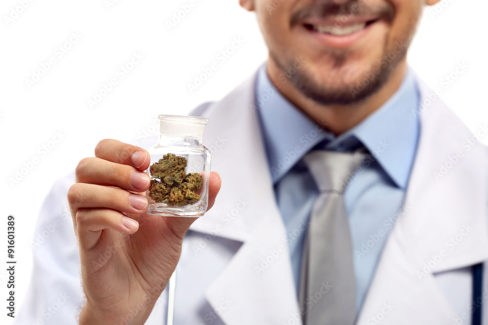Doctor hand holding bottle with medical cannabis close up Doctor hand holding bottle with medical cannabis close up