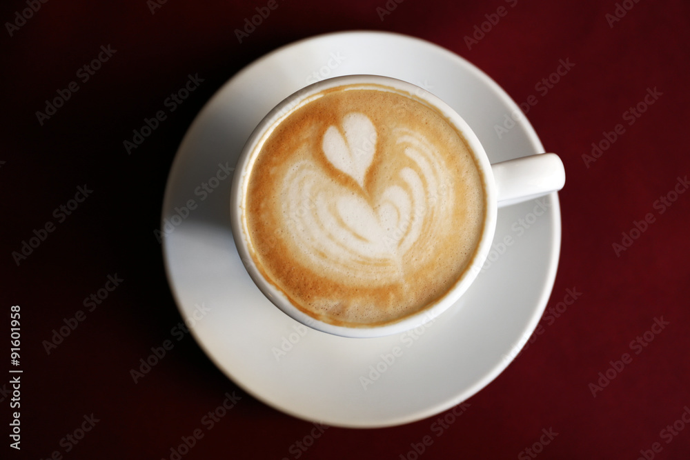 Cup of cappuccino on red napkin, top view Cup of cappuccino on red napkin, top view