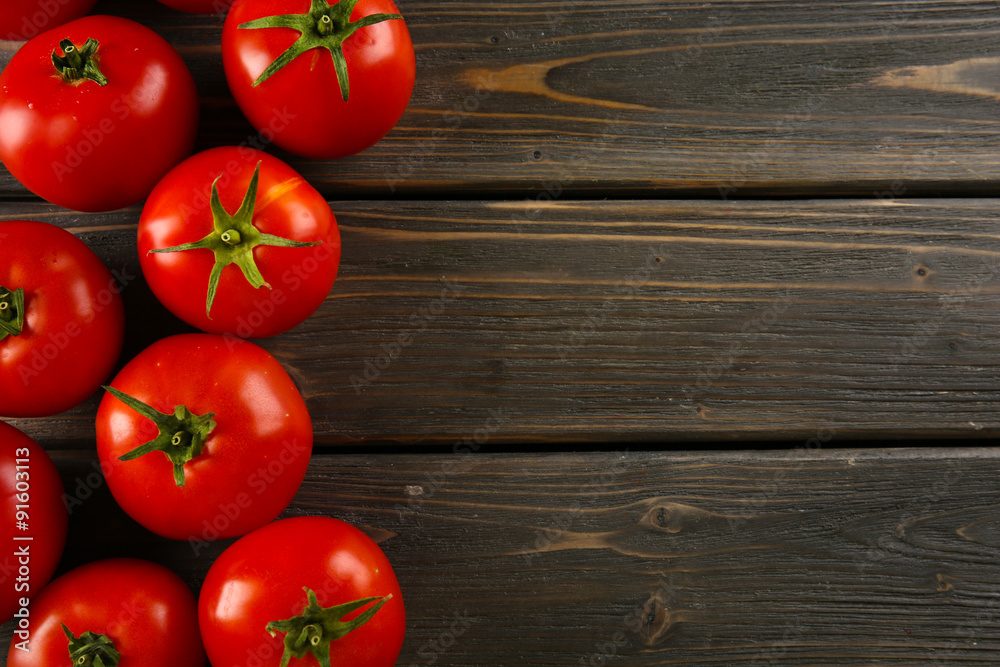 Red tomatoes on wooden background Red tomatoes on wooden background