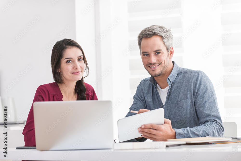 Portrait of a smiling couple doing their accounting A dark hair Portrait of a smiling couple doing their accounting A dark hair