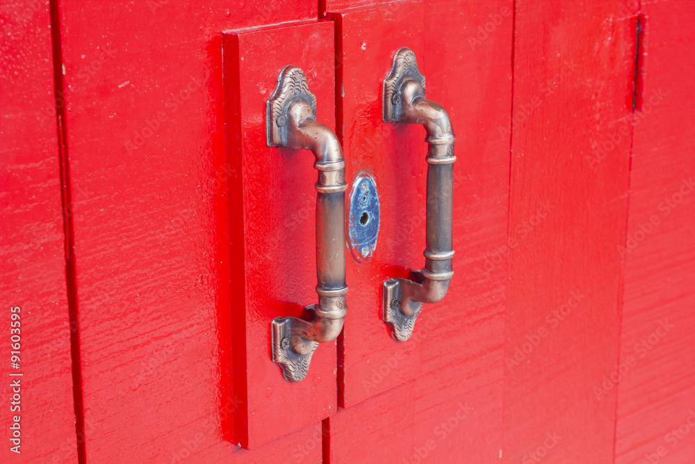 Door handles on red wooden door Door handles on red wooden door