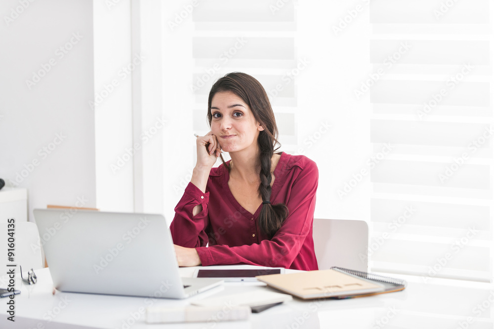 Portrait of a dark braided hair woman home working in casual clo Portrait of a dark braided hair woman home working in casual clo