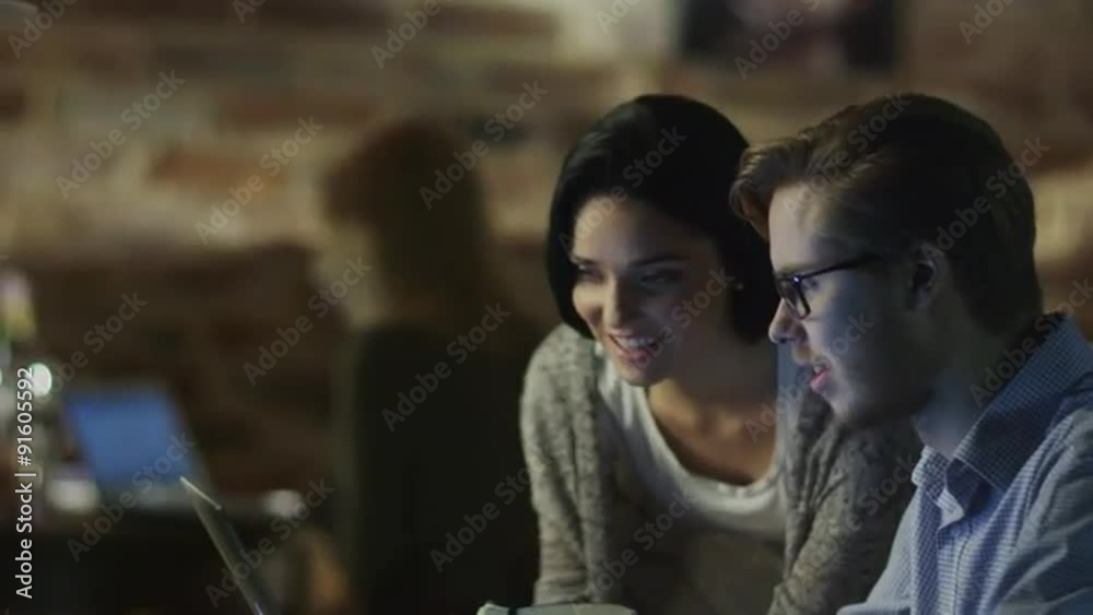 Students have Discussion in Coffee Shop. Young Man Typing on Laptop. Casual Lifestyle.