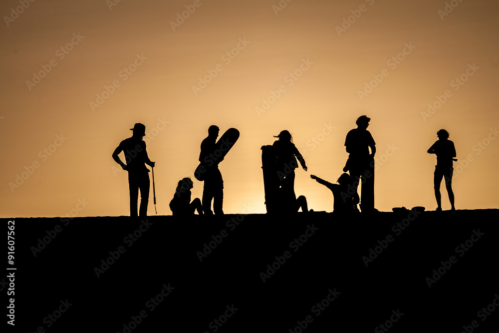 Silhouettes of sand boarders