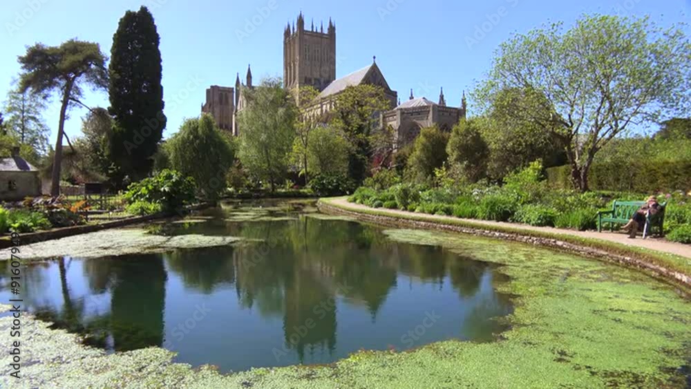 An establishing shot of the main cathedral abbey of Wells, England with botanical gardens foreground. An establishing shot of the main cathedral abbey of Wells, England with botanical gardens foreground.