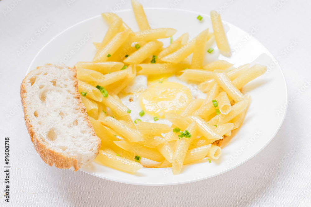 Plate with pasta and fried eggs Plate with pasta and fried eggs