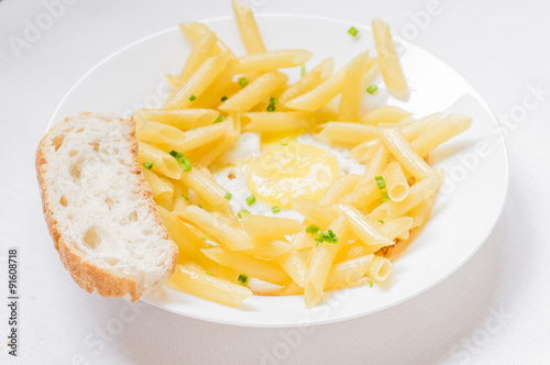 Plate with pasta and fried eggs