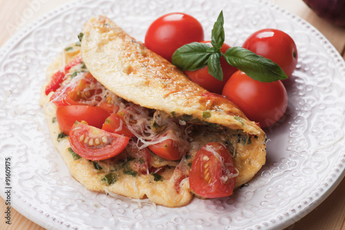 Omelet with cheese and cherry tomato