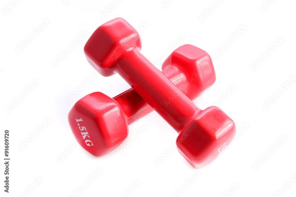 Two red dumbbells on white background. Light weight, one kilogra Two red dumbbells on white background. Light weight, one kilogra