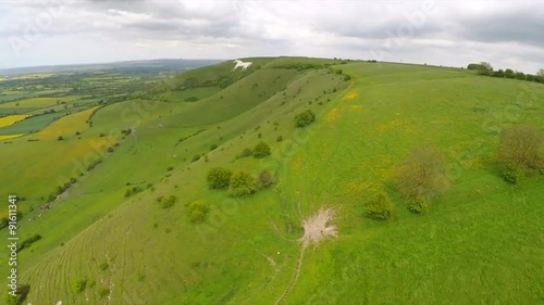 Aerial over a giant white horse with farm fields foreground in Westbury, England. photo