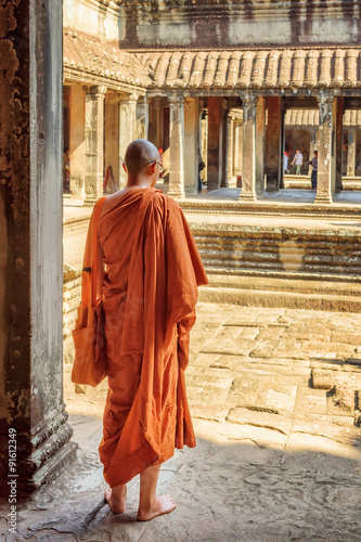 Tablou canvas Buddhist monk exploring courtyards of Angkor Wat in Cambodia
