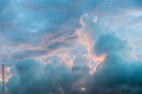 Stormy sunset sky with soft fluffy clouds