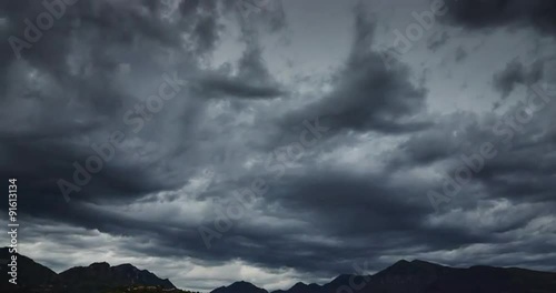 Darkness dramatic sky over the mountains, floating clouds, time lapse 4k video