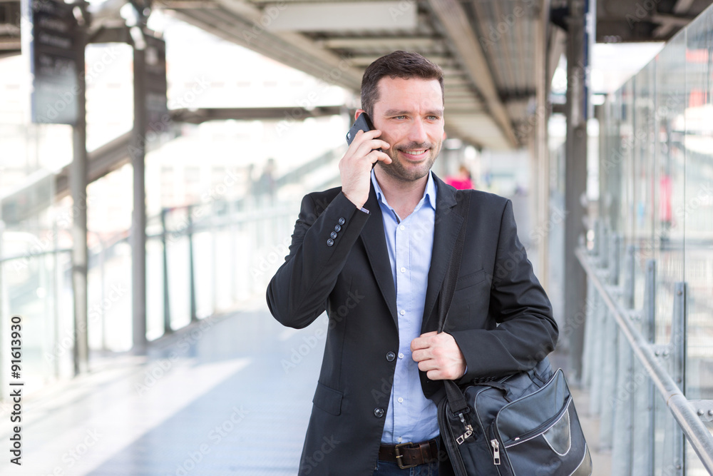 Young attractive business man using smartphone
