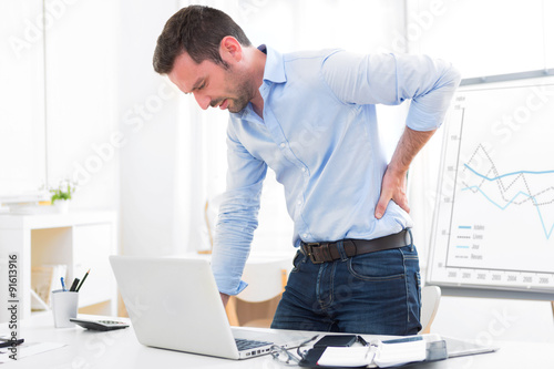 Young attractive business got backache because of burn out