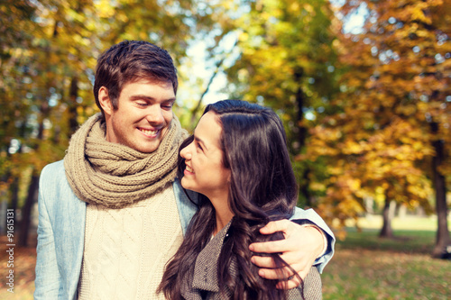 smiling couple hugging in autumn park